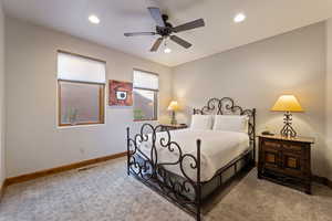 Bedroom featuring ceiling fan, light colored carpet, and recessed lighting