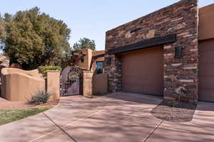 Garage featuring a gate and driveway