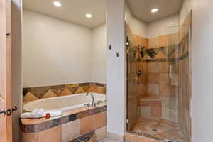 Bathroom with a bath, a shower stall, and recessed lighting