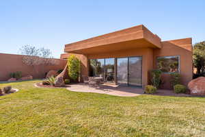 Rear view of property featuring a patio and stucco siding