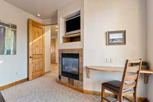 Living room with a tile fireplace and carpet floors