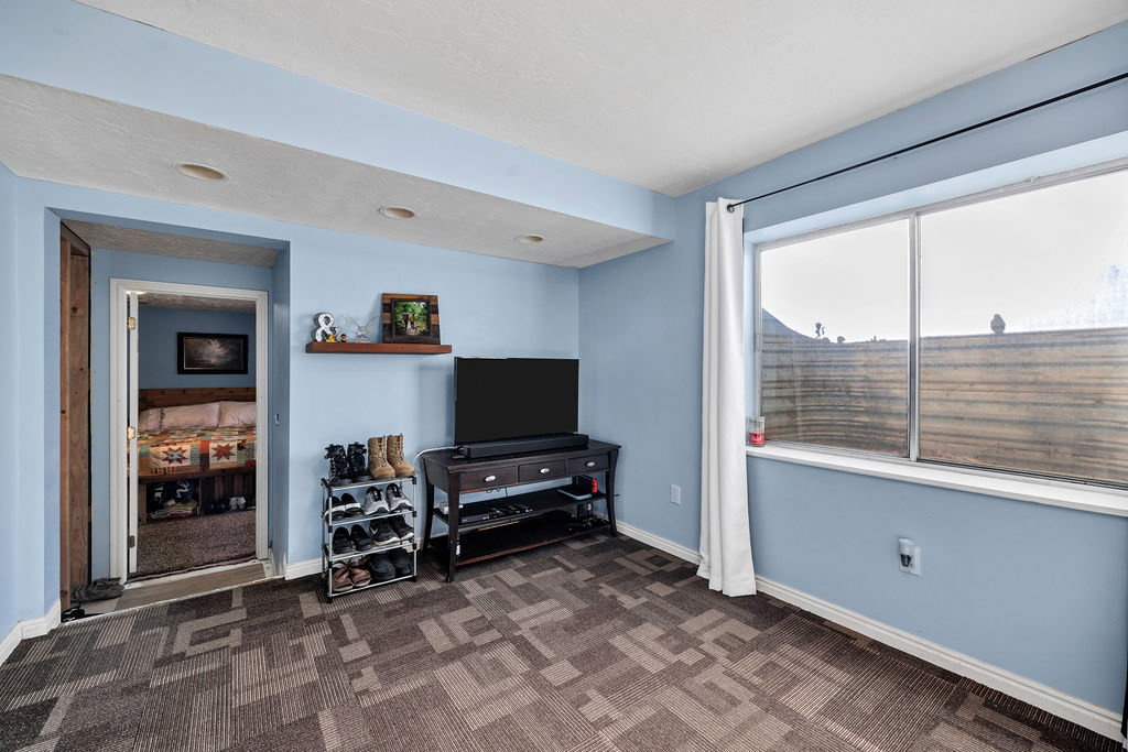 Living room with dark colored carpet and baseboards