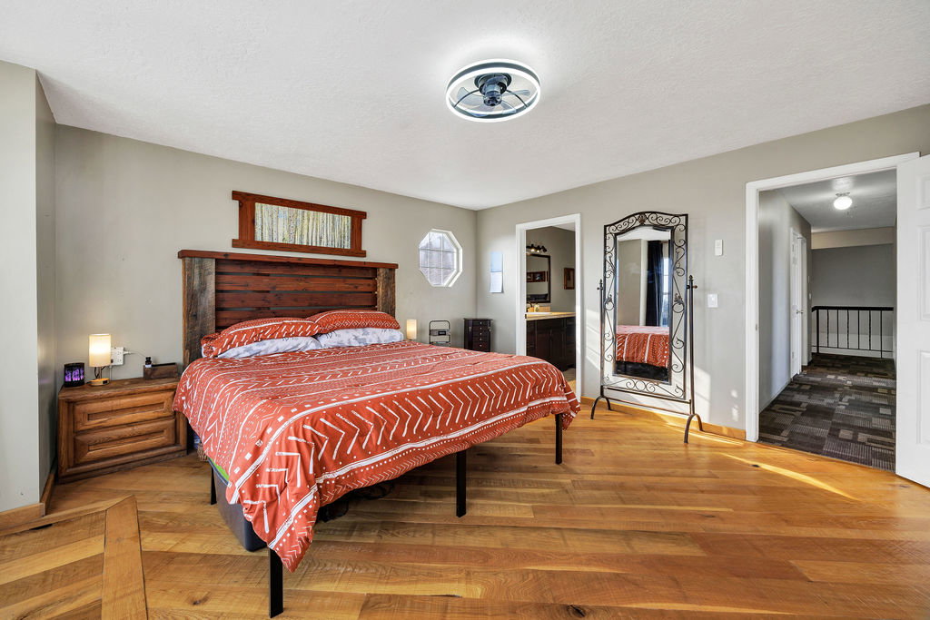 Bedroom with wood finished floors and ensuite bathroom