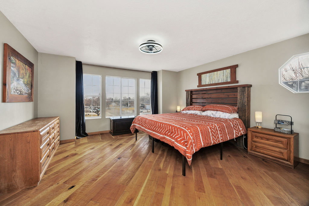 Bedroom featuring light wood finished floors and baseboards