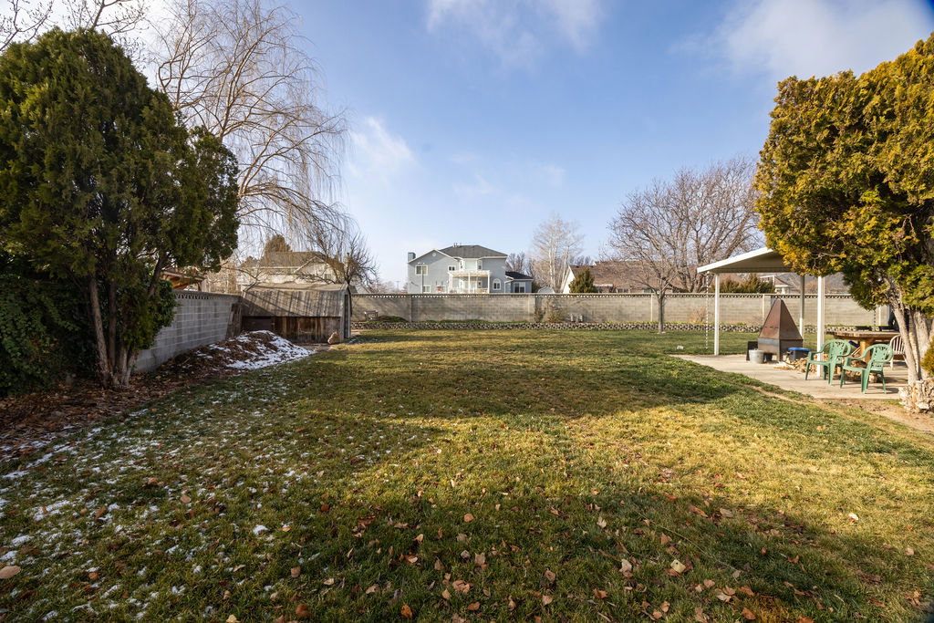 Fenced backyard with a patio