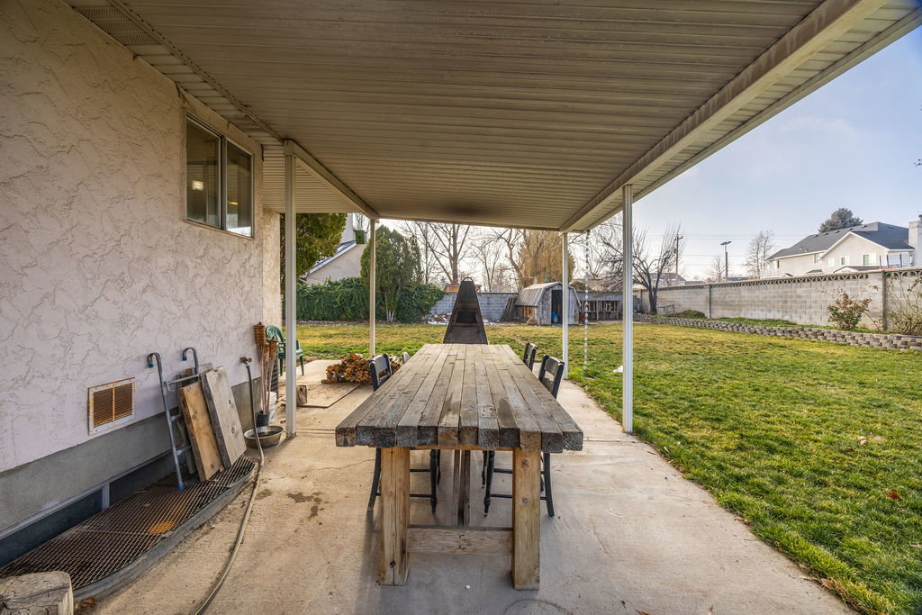 Fenced backyard with outdoor dining area, a patio area, and a storage shed