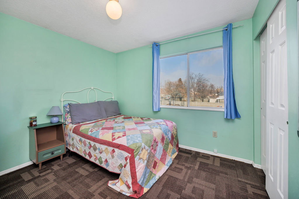 Bedroom with a closet and dark colored carpet
