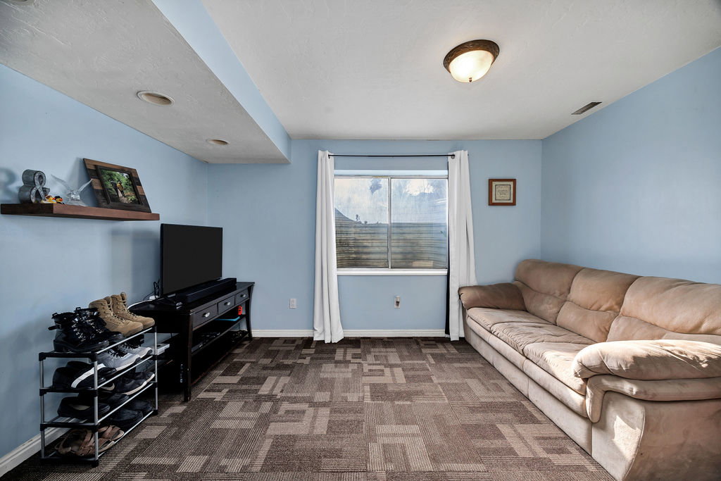 Living room with carpet flooring and baseboards