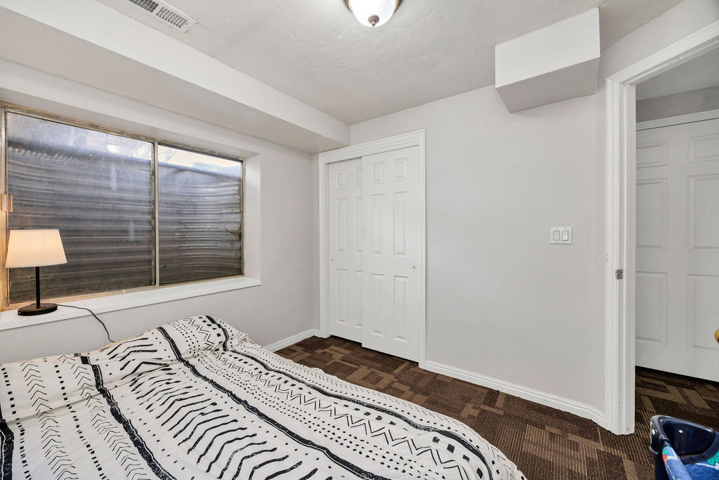 Bedroom with baseboards and a closet