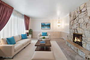 Carpeted front living area with ornamental molding and a fireplace