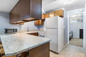 Separate-entrance mother-in-law basement apartment with full kitchen.