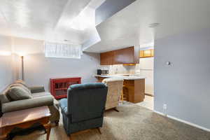 Mother In law basement apartment Living area with light colored carpet and baseboards
