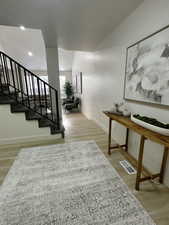 Staircase featuring wood finished floors and baseboards