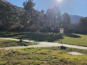 Surrounding community featuring a lawn and a mountain view