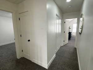 Hallway with dark carpet