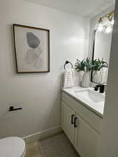 Bathroom featuring vanity and a textured ceiling