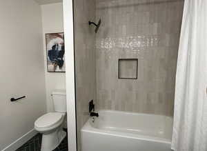 Full bathroom with shower / bathtub combination with curtain and tile patterned floors