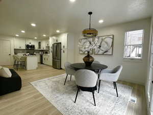 Dining room featuring light wood finished floors and recessed lighting