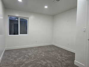 Unfurnished room featuring dark carpet and recessed lighting