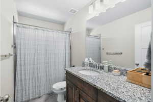 Full bathroom with vanity and toilet