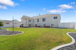 Back of property with a hot tub, stairs, a fenced backyard, and a patio