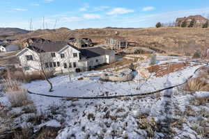 Snow covered house with a residential view and a mountain view