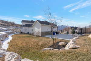 View of home's exterior featuring a patio area, a mountain view, and stone siding