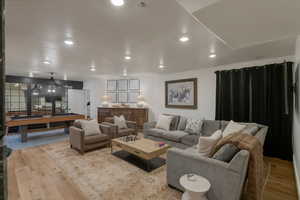 Living room with pool table, hardwood / wood-style flooring, and recessed lighting