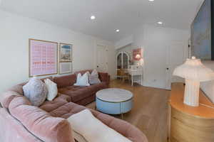 Living area with wood finished floors and lofted ceiling