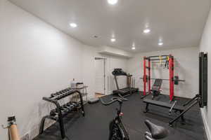 Workout area with recessed lighting and rubber floors