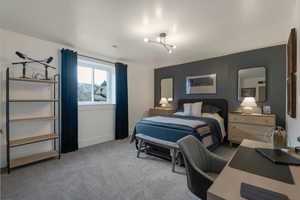 Bedroom featuring light colored carpet and baseboards