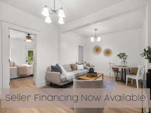 Living room with a chandelier and light wood-style flooring