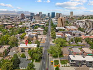 Aerial view of property's location with nearby urban area and a mountain backdrop