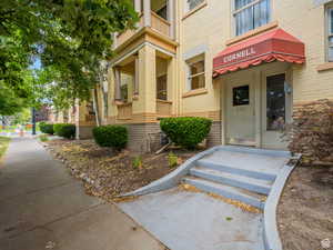 View of exterior entry with brick siding