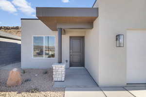 Property entrance featuring stucco siding