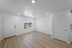 Unfurnished room featuring light wood-type flooring and recessed lighting