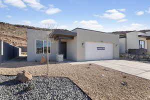 Contemporary home with stucco siding, driveway, and an attached garage