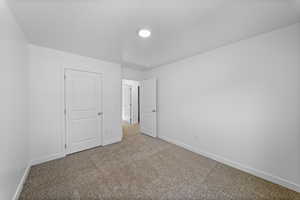 Unfurnished bedroom with baseboards and carpet floors