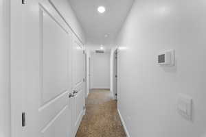 Hall with carpet and recessed lighting