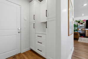 Detailed view of wood finished floors and recessed lighting