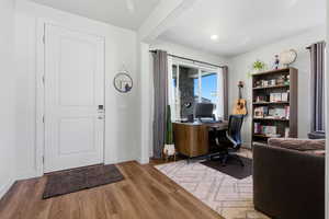 Office space with wood finished floors and baseboards