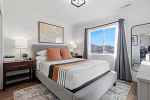 Bedroom with dark wood-type flooring