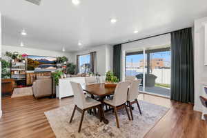 Dining space featuring light wood finished floors, recessed lighting, and a textured ceiling