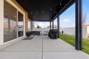Fenced backyard featuring an outdoor living space, a patio area, and a grill