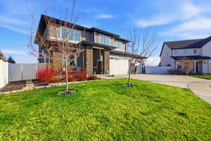 View of front of house featuring concrete driveway and a garage
