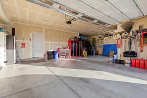 Garage with stainless steel fridge with ice dispenser