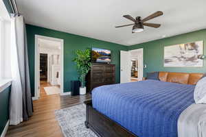Bedroom with wood finished floors and a ceiling fan