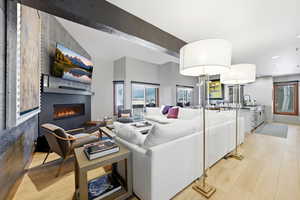 Living room featuring a fireplace, light wood-type flooring, and recessed lighting