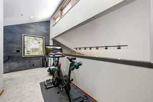 Workout room featuring light colored carpet, an accent wall, and recessed lighting
