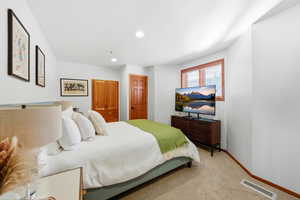 Carpeted bedroom with baseboards and recessed lighting